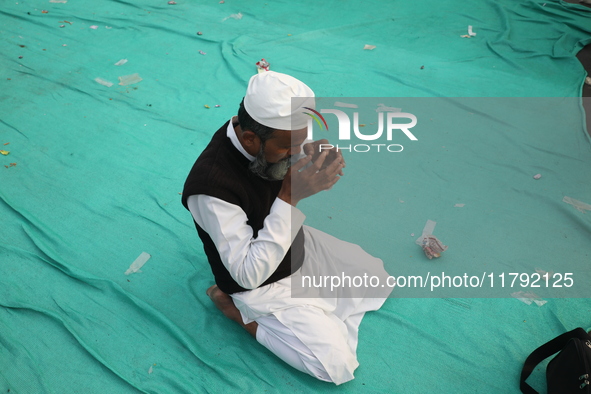 An activist of The All India Youth Federation (AIYF) offers a prayer after attending a protest meeting in Kolkata, India, on November 19, 20...