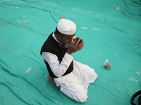 An activist of The All India Youth Federation (AIYF) offers a prayer after attending a protest meeting in Kolkata, India, on November 19, 20...