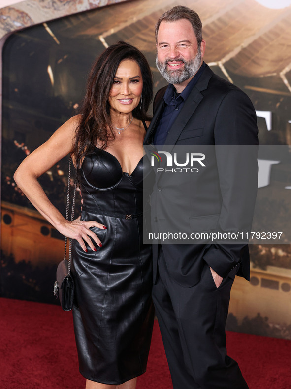 Tia Carrere and boyfriend Paul Debevec arrive at the Los Angeles Premiere Of Paramount Pictures' 'Gladiator II' held at the TCL Chinese Thea...