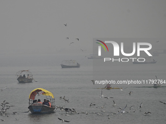 People take boat rides amid heavy smoggy conditions at Sangam, the confluence of the rivers Ganges, Yamuna, and Saraswati, in Prayagraj, Ind...