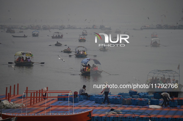 People take boat rides amid heavy smoggy conditions at Sangam, the confluence of the rivers Ganges, Yamuna, and Saraswati, in Prayagraj, Ind...