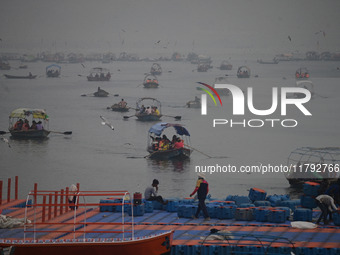 People take boat rides amid heavy smoggy conditions at Sangam, the confluence of the rivers Ganges, Yamuna, and Saraswati, in Prayagraj, Ind...