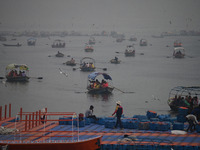 People take boat rides amid heavy smoggy conditions at Sangam, the confluence of the rivers Ganges, Yamuna, and Saraswati, in Prayagraj, Ind...