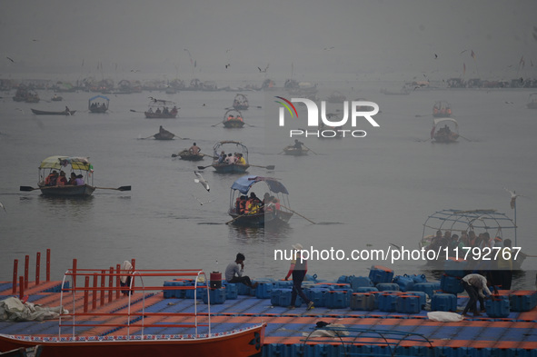 People take boat rides amid heavy smoggy conditions at Sangam, the confluence of the rivers Ganges, Yamuna, and Saraswati, in Prayagraj, Ind...