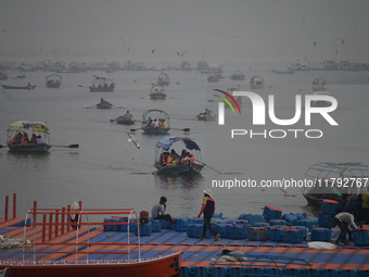 People take boat rides amid heavy smoggy conditions at Sangam, the confluence of the rivers Ganges, Yamuna, and Saraswati, in Prayagraj, Ind...