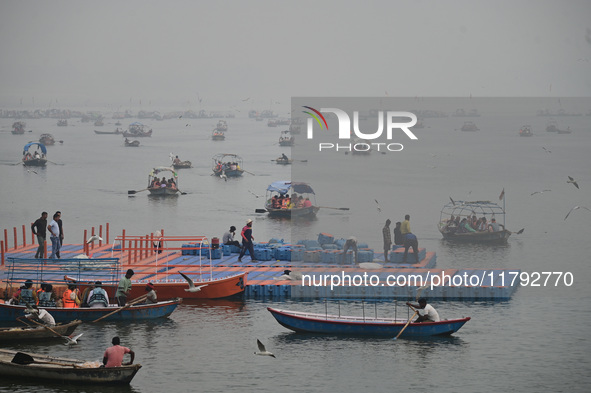 People take boat rides amid heavy smoggy conditions at Sangam, the confluence of the rivers Ganges, Yamuna, and Saraswati, in Prayagraj, Ind...