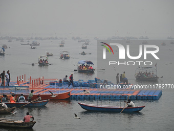 People take boat rides amid heavy smoggy conditions at Sangam, the confluence of the rivers Ganges, Yamuna, and Saraswati, in Prayagraj, Ind...