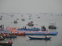 People take boat rides amid heavy smoggy conditions at Sangam, the confluence of the rivers Ganges, Yamuna, and Saraswati, in Prayagraj, Ind...