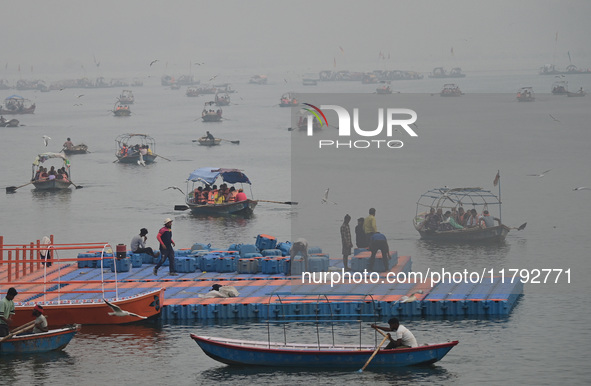 People take boat rides amid heavy smoggy conditions at Sangam, the confluence of the rivers Ganges, Yamuna, and Saraswati, in Prayagraj, Ind...