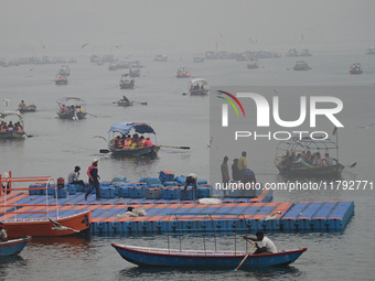 People take boat rides amid heavy smoggy conditions at Sangam, the confluence of the rivers Ganges, Yamuna, and Saraswati, in Prayagraj, Ind...