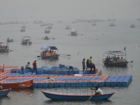 People take boat rides amid heavy smoggy conditions at Sangam, the confluence of the rivers Ganges, Yamuna, and Saraswati, in Prayagraj, Ind...