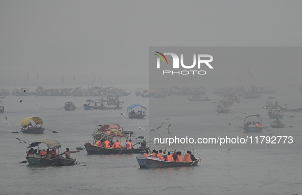 People take boat rides amid heavy smoggy conditions at Sangam, the confluence of the rivers Ganges, Yamuna, and Saraswati, in Prayagraj, Ind...