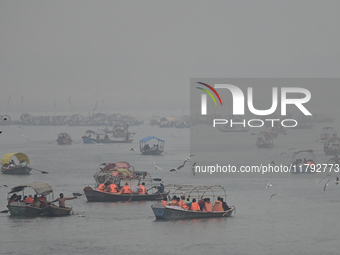 People take boat rides amid heavy smoggy conditions at Sangam, the confluence of the rivers Ganges, Yamuna, and Saraswati, in Prayagraj, Ind...