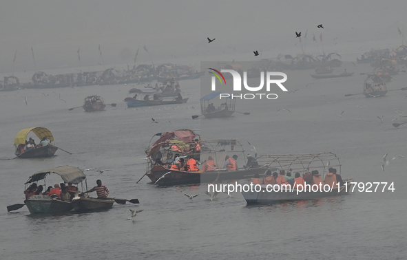 People take boat rides amid heavy smoggy conditions at Sangam, the confluence of the rivers Ganges, Yamuna, and Saraswati, in Prayagraj, Ind...