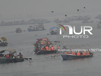 People take boat rides amid heavy smoggy conditions at Sangam, the confluence of the rivers Ganges, Yamuna, and Saraswati, in Prayagraj, Ind...