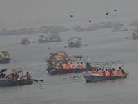 People take boat rides amid heavy smoggy conditions at Sangam, the confluence of the rivers Ganges, Yamuna, and Saraswati, in Prayagraj, Ind...