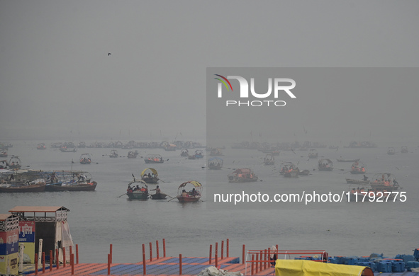 People take boat rides amid heavy smoggy conditions at Sangam, the confluence of the rivers Ganges, Yamuna, and Saraswati, in Prayagraj, Ind...