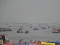 People take boat rides amid heavy smoggy conditions at Sangam, the confluence of the rivers Ganges, Yamuna, and Saraswati, in Prayagraj, Ind...