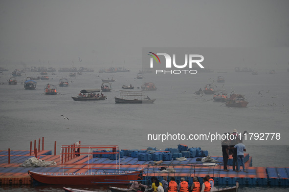 People take boat rides amid heavy smoggy conditions at Sangam, the confluence of the rivers Ganges, Yamuna, and Saraswati, in Prayagraj, Ind...