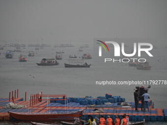 People take boat rides amid heavy smoggy conditions at Sangam, the confluence of the rivers Ganges, Yamuna, and Saraswati, in Prayagraj, Ind...