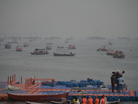 People take boat rides amid heavy smoggy conditions at Sangam, the confluence of the rivers Ganges, Yamuna, and Saraswati, in Prayagraj, Ind...