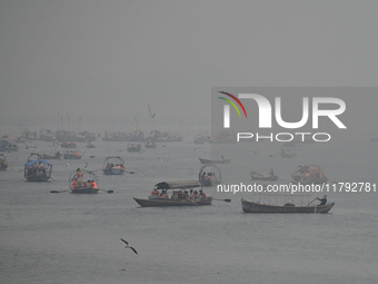 People take boat rides amid heavy smoggy conditions at Sangam, the confluence of the rivers Ganges, Yamuna, and Saraswati, in Prayagraj, Ind...