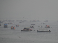 People take boat rides amid heavy smoggy conditions at Sangam, the confluence of the rivers Ganges, Yamuna, and Saraswati, in Prayagraj, Ind...