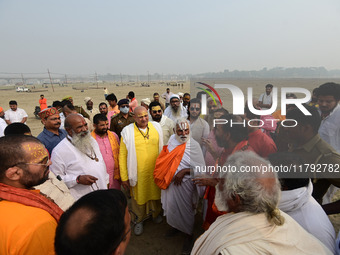 Sadhus (holy men) arrive on the banks of the Sangam area for the allotment of land for the Maha Kumbh 2025 Festival in Prayagraj, India, on...