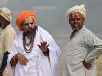 Sadhus (holy men) arrive on the banks of the Sangam area for the allotment of land for the Maha Kumbh 2025 Festival in Prayagraj, India, on...