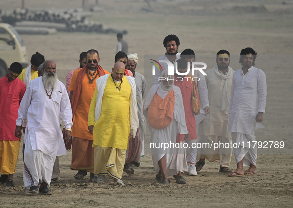 Sadhus (holy men) arrive on the banks of the Sangam area for the allotment of land for the Maha Kumbh 2025 Festival in Prayagraj, India, on...