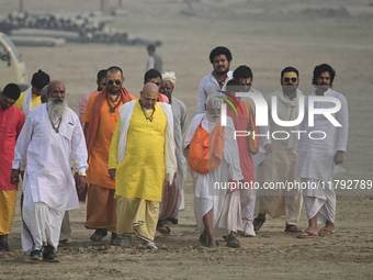 Sadhus (holy men) arrive on the banks of the Sangam area for the allotment of land for the Maha Kumbh 2025 Festival in Prayagraj, India, on...