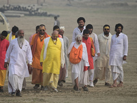 Sadhus (holy men) arrive on the banks of the Sangam area for the allotment of land for the Maha Kumbh 2025 Festival in Prayagraj, India, on...