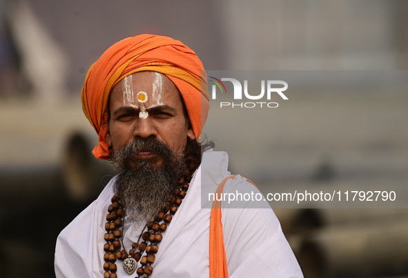 A Sadhu (holy man) walks on the banks of the Sangam area as he arrives for the allotment of land for the Maha Kumbh 2025 Festival in Prayagr...