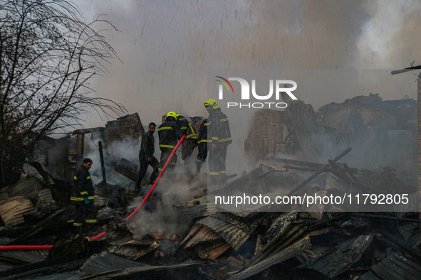 Firefighters work to extinguish a fire on residential houses in Srinagar, Jammu and Kashmir, on November 19, 2024. 