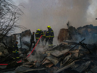 Firefighters work to extinguish a fire on residential houses in Srinagar, Jammu and Kashmir, on November 19, 2024. (