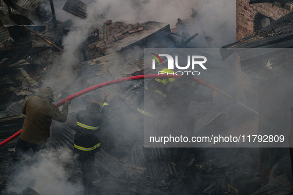 Firefighters work to extinguish a fire on residential houses in Srinagar, Jammu and Kashmir, on November 19, 2024. 