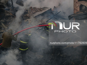 Firefighters work to extinguish a fire on residential houses in Srinagar, Jammu and Kashmir, on November 19, 2024. (