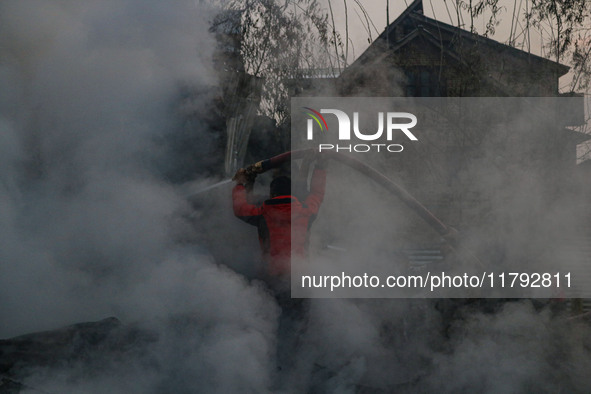 Firefighters work to extinguish a fire on residential houses in Srinagar, Jammu and Kashmir, on November 19, 2024. 