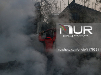 Firefighters work to extinguish a fire on residential houses in Srinagar, Jammu and Kashmir, on November 19, 2024. (