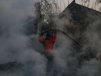 Firefighters work to extinguish a fire on residential houses in Srinagar, Jammu and Kashmir, on November 19, 2024. (