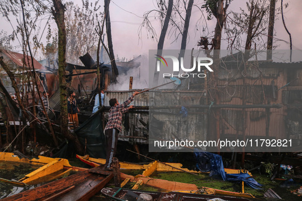 Civilians work to extinguish a fire on residential houses in Srinagar, Jammu and Kashmir, on November 19, 2024. 