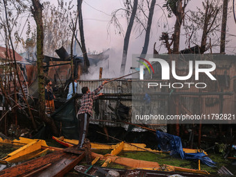 Civilians work to extinguish a fire on residential houses in Srinagar, Jammu and Kashmir, on November 19, 2024. (