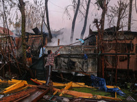 Civilians work to extinguish a fire on residential houses in Srinagar, Jammu and Kashmir, on November 19, 2024. (