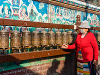 A devotee rounds the prayer wheel around the Boudhanath Stupa in Kathmandu, Nepal, on November 19, 2024. (