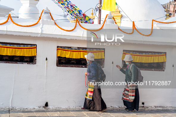 A devotee rounds the prayer wheel around the Boudhanath Stupa in Kathmandu, Nepal, on November 19, 2024. 