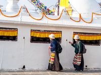 A devotee rounds the prayer wheel around the Boudhanath Stupa in Kathmandu, Nepal, on November 19, 2024. (