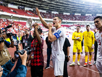 Jay Noah Idzes of Indonesia talks to a supporter after celebrating their victory in the FIFA World Cup Asian 3rd Qualifier Group C match aga...