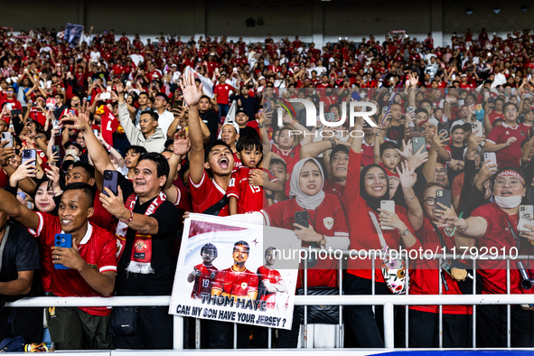 Indonesian fans cheer after the FIFA World Cup Asian 3rd Qualifier Group C match against Saudi Arabia at Gelora Bung Karno Stadium in Jakart...