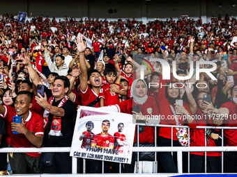 Indonesian fans cheer after the FIFA World Cup Asian 3rd Qualifier Group C match against Saudi Arabia at Gelora Bung Karno Stadium in Jakart...