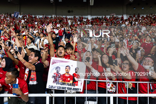 Indonesian fans cheer after the FIFA World Cup Asian 3rd Qualifier Group C match against Saudi Arabia at Gelora Bung Karno Stadium in Jakart...